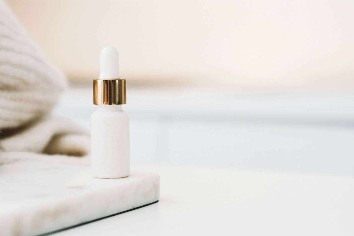 Skincare dropper bottle shown in an illustrative background-removal preview